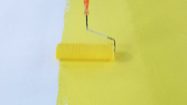 The roller is painted yellow on the floor.