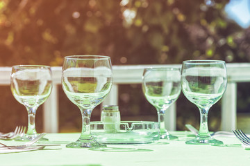 Picture of glasses on the white table, toned