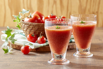Tomato and tomato juice on a wooden table