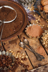 Roasted black and green coffee beans and ground coffee in the plate