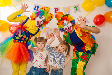 clown girl and clown boy at the birthday of a child. Party for children. Play and entertain boys and girls