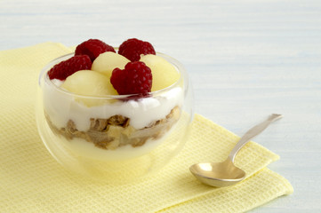 Homemade natural yogurt with melon and raspberry.