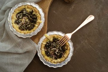 Cakes with spinach on a wooden Board.