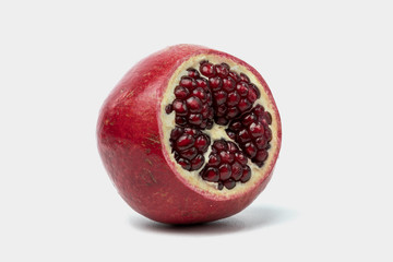 Ripe pomegranate fruit on white background cutout