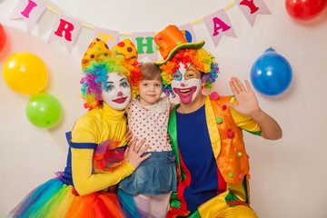 clown boy and clown girl on birthday girl. Party for children. Clowns amuse the child