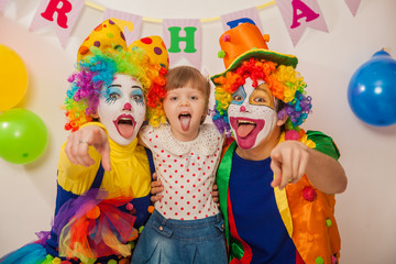 clown boy and clown girl on birthday girl. Party for children. Clowns amuse the child