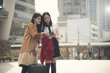 young woman tourist using gps map in a smart phone in the city background.