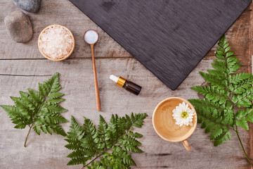 aromatherapy: bath salt, cosmetic cream, organic soap and green leave on wooden table