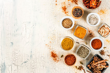 Set of various spices on light concrete background. Copy space.