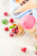 Summer sweet berries and desserts, various of ice cream flavor in cones pink (raspberry), vanilla and chocolate with mint on light concrete background copy space