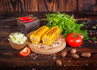 Grilled corn with spices, herbs and tomatoes