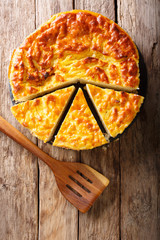 Homemade rice pie with cottage cheese, eggs and sugar close-up. Vertical top view from above