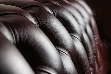 texture of the dark leather couch stitched buttons