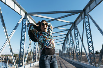  Beautiful girl having fun in the iron bridge