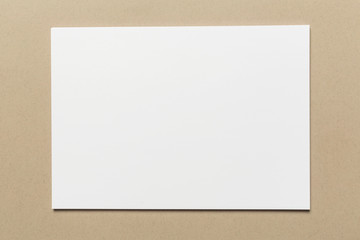 White business card on wooden table. Blank portrait A4.