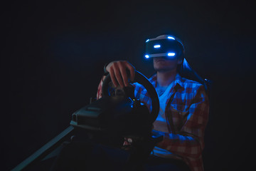 Man plays three-dimensional video games in glasses of virtual reality. Racing vr on car simulator