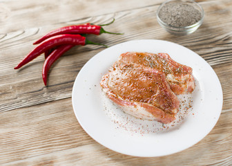 Raw pork ribs with hot red pepper. Preparation of meat for grilling.