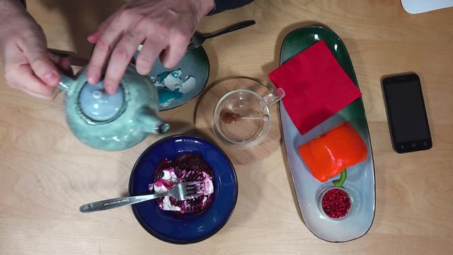 Top view with breakfast, tea, egg, salad and smartphone.