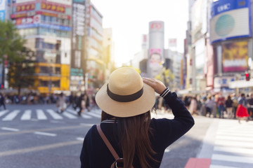 Woman is travelling at Shibuya junction in Tokyo, Japan.