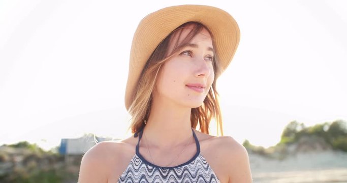 Beautiful blond girl enjoying the sumer breeze at a beach