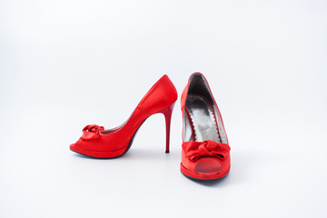 red female shoes with a bow on a white background 