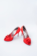 red female shoes with a bow on a white background 