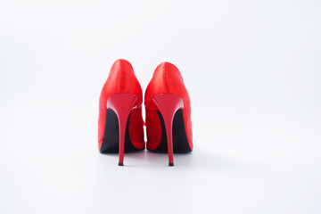 red female shoes with a bow on a white background 