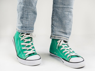 Stylish, bright, green sneakers and funny, happy socks on a white background. Sport, style, beauty, good mood