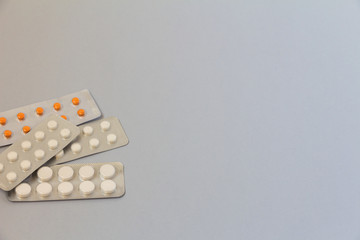 tablets in blisters on a light blue background. soft focus