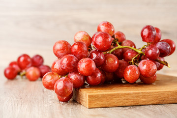 Red grapes on wooden table