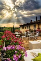Preparation of an event at a classic Tuscan villa illuminated by special rays of sunlight that cross the clouds