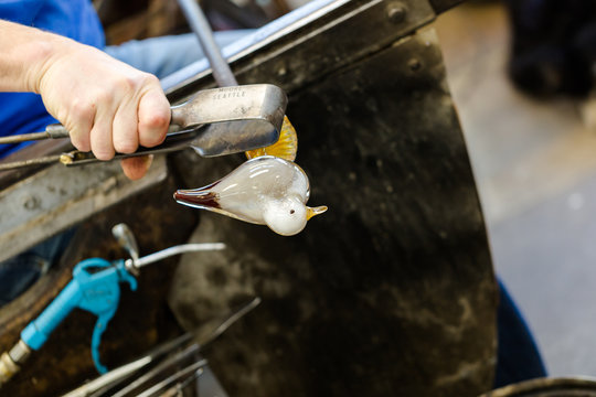 Glass Artist Works On Seagull Sculpture Made From Hot Glass