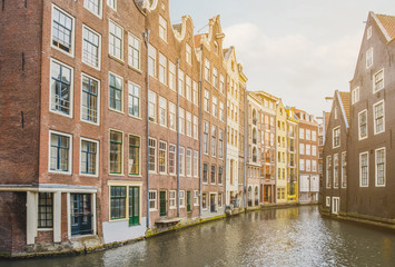 Fototapeta na wymiar Traditional old building facade in Amsterdam, canal coast 