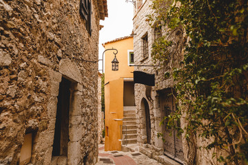 ancient stone buildings on narrow street of old town, Eze, France