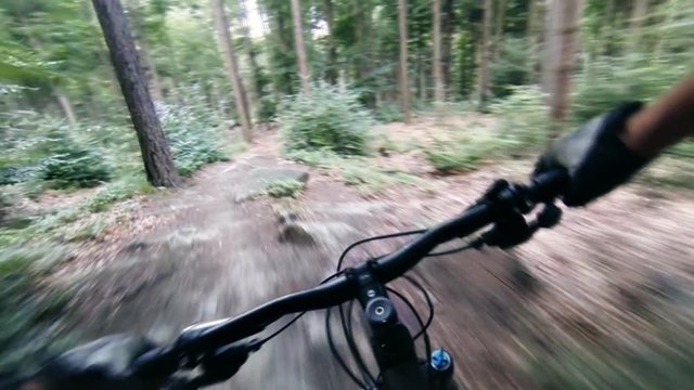 Speed riding downhill a MTB bike on rocky mountain. View from first person perspective POV. Gimbal stabilized view.