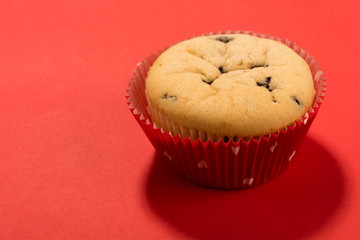 a muffin on a red background with a red mould