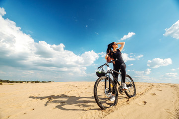 Fototapeta premium Enjoy moment. Female cyclist cycling on track with road bicycle speed and sprint and sports wellness concept. Sunglasses.