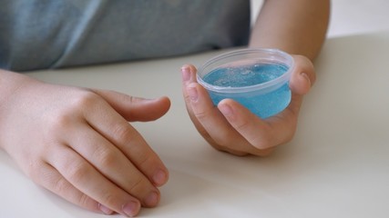 Close up on hands playing with DIY slime