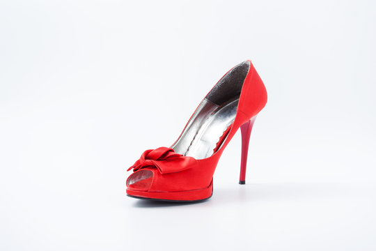 red female shoes with a bow on a white background 