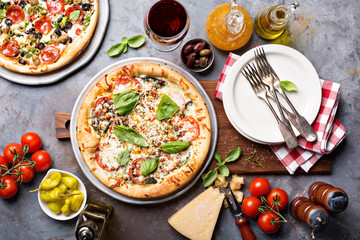 Margherita and pepperoni pizza with basil