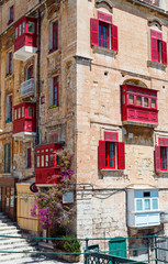 Old architecture building with red balconies 