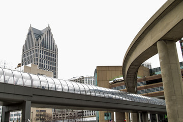 Obraz premium Getting Around Detroit. Downtown skyline with a pedestrian bridge, monorail track and skyscrapers.