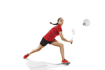 Young woman playing badminton over white background