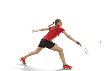 Young woman playing badminton over white background