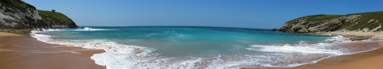 Fototapeta na wymiar Beach with beautiful waves and blue sky, landscape. North Spain
