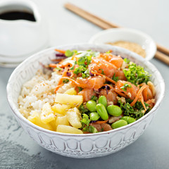 Poke bowl with raw salmon, rice and vegetables