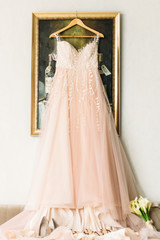 Wedding Dress. wedding dress gently pink color. wedding dress on a hanger