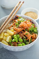 Poke bowl with raw salmon, rice and vegetables