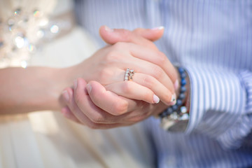 Obraz na płótnie Canvas wedding theme, man and woman holding hands with a nice manicure neat.