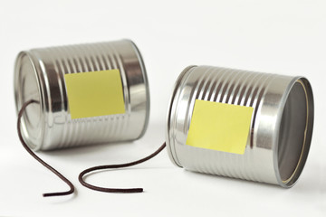 Tin cans phone with broken string and paper note - Communication concept